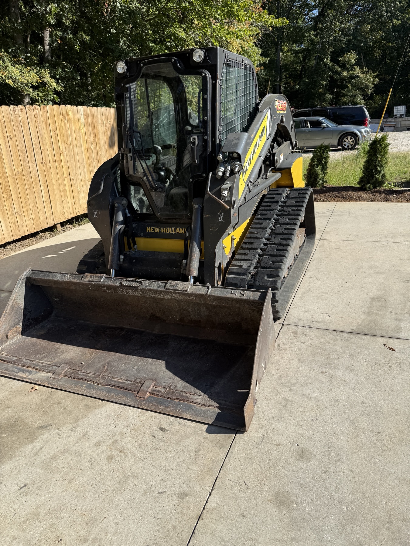 Front view of the New Holland C238 enclosed cab and smooth bucket