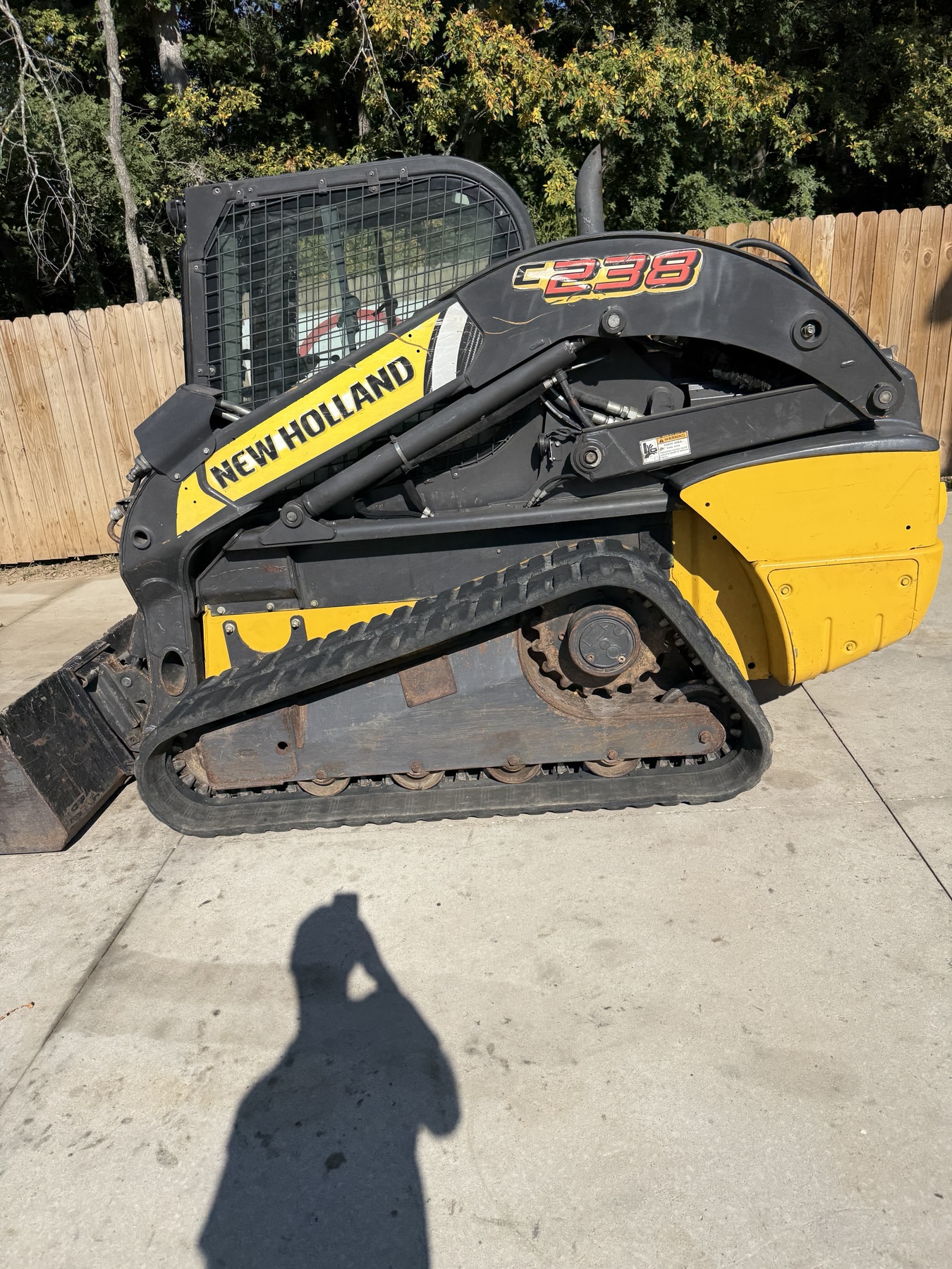 New Holland C238 right-side profile showing track and undercarriage