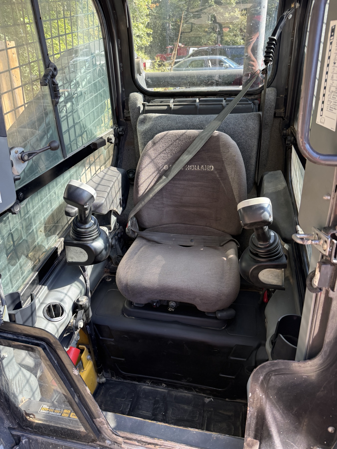New Holland C238 enclosed cab with operator seat and dual controls