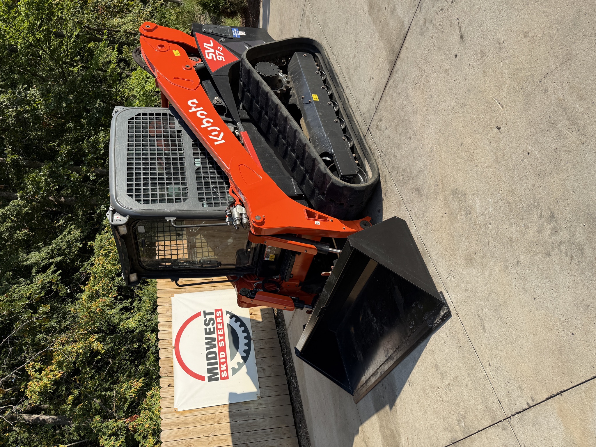 2024 Kubota SVL97-2 front three-quarter view with smooth bucket