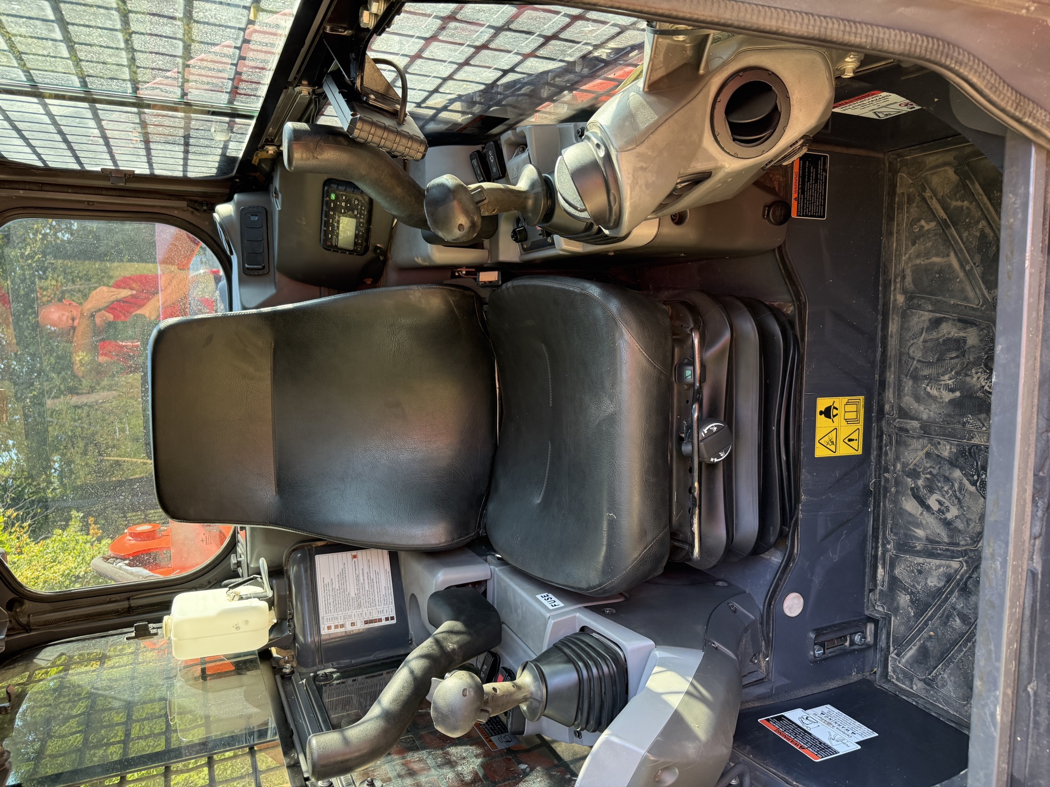 Kubota SVL97-2 enclosed cab with operator seat and dual controls