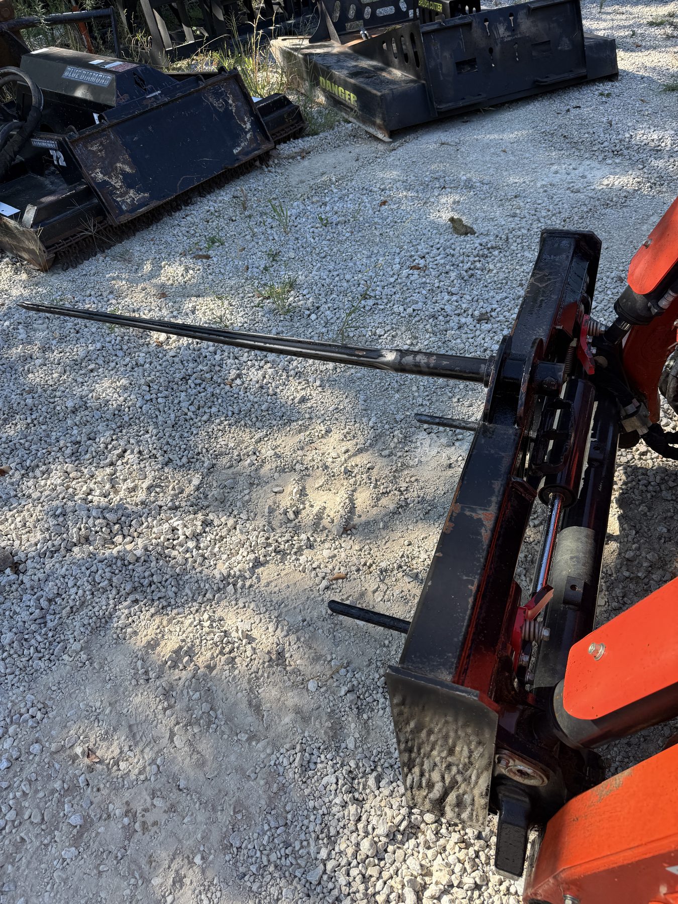 Bale spear attachment mounted on a compact track loader